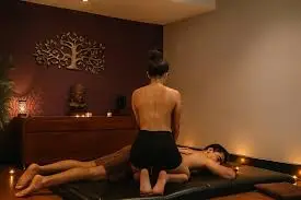 Client enjoying a full body Nuru massage session at a luxury spa with soft lighting and peaceful ambiance